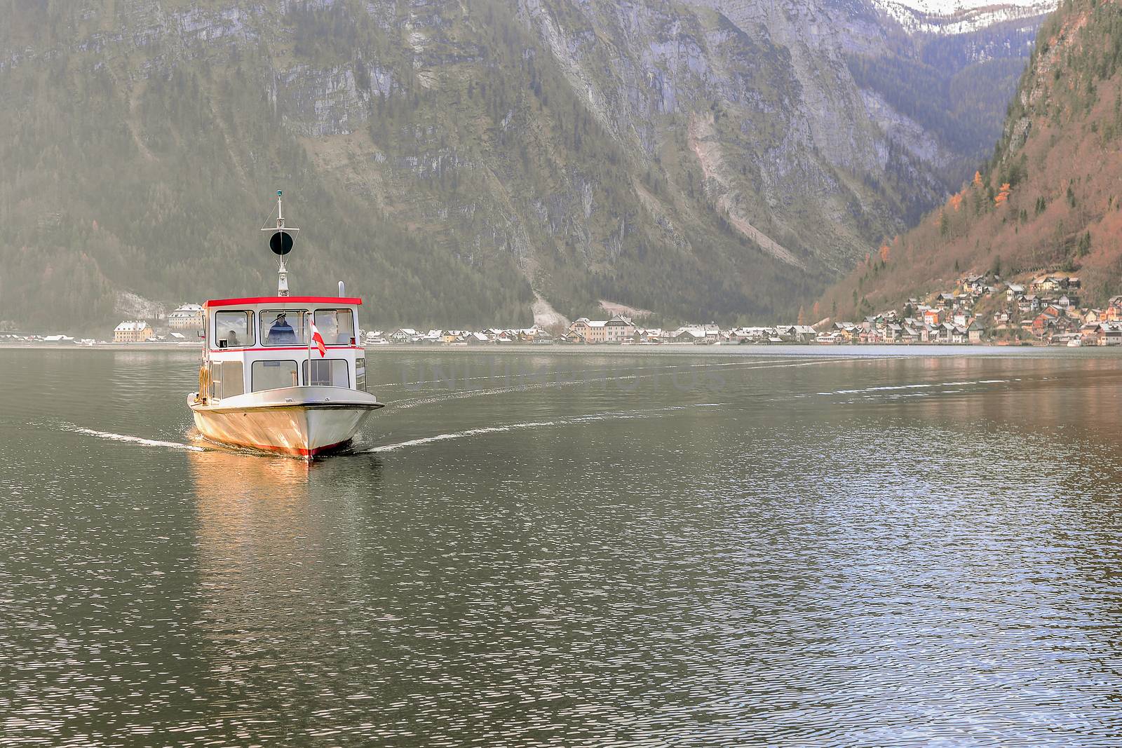 Ferry in Hallstatt Lake with Hallstat village background, Salzkammergut, Austria