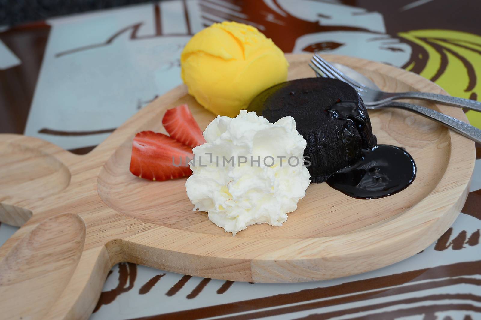 chocolate fondant with vanilla ice cream on wooden plate