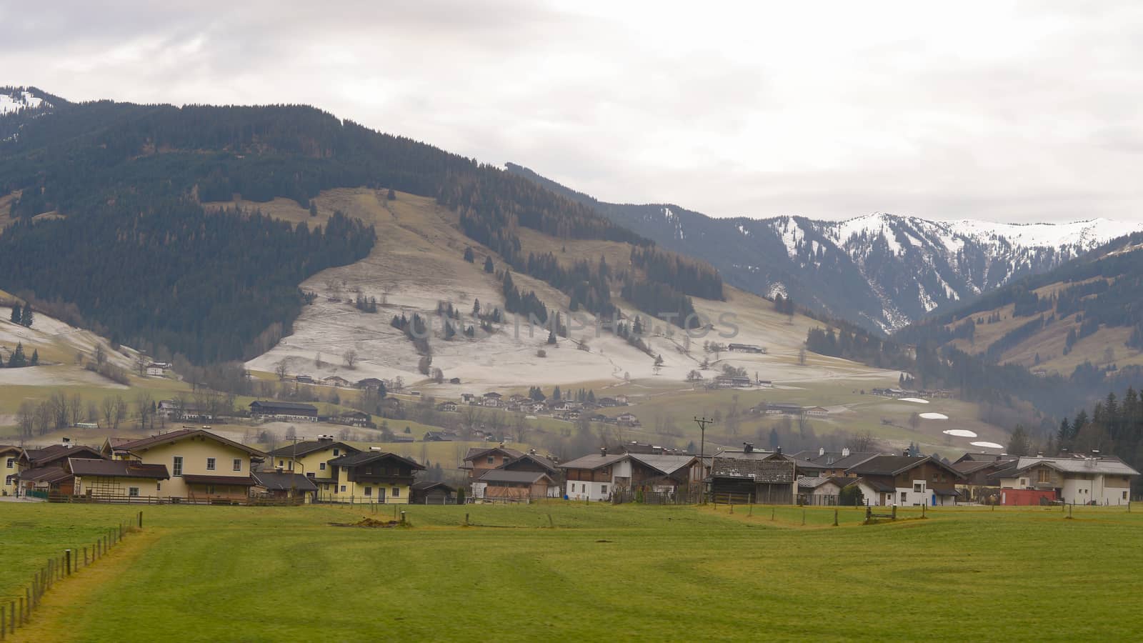 Beautiful landscape of valley in Alpine mountains in early winter, taking view on train from Austria to Switzerland