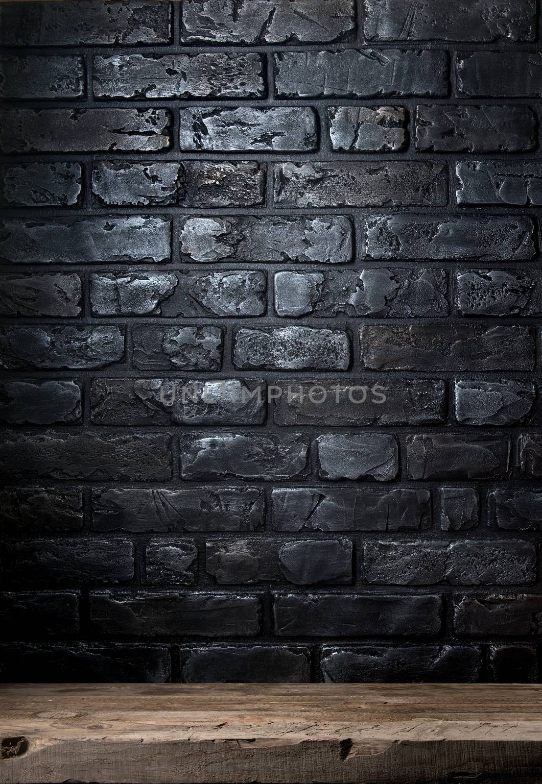 Black brick wall and old wooden table