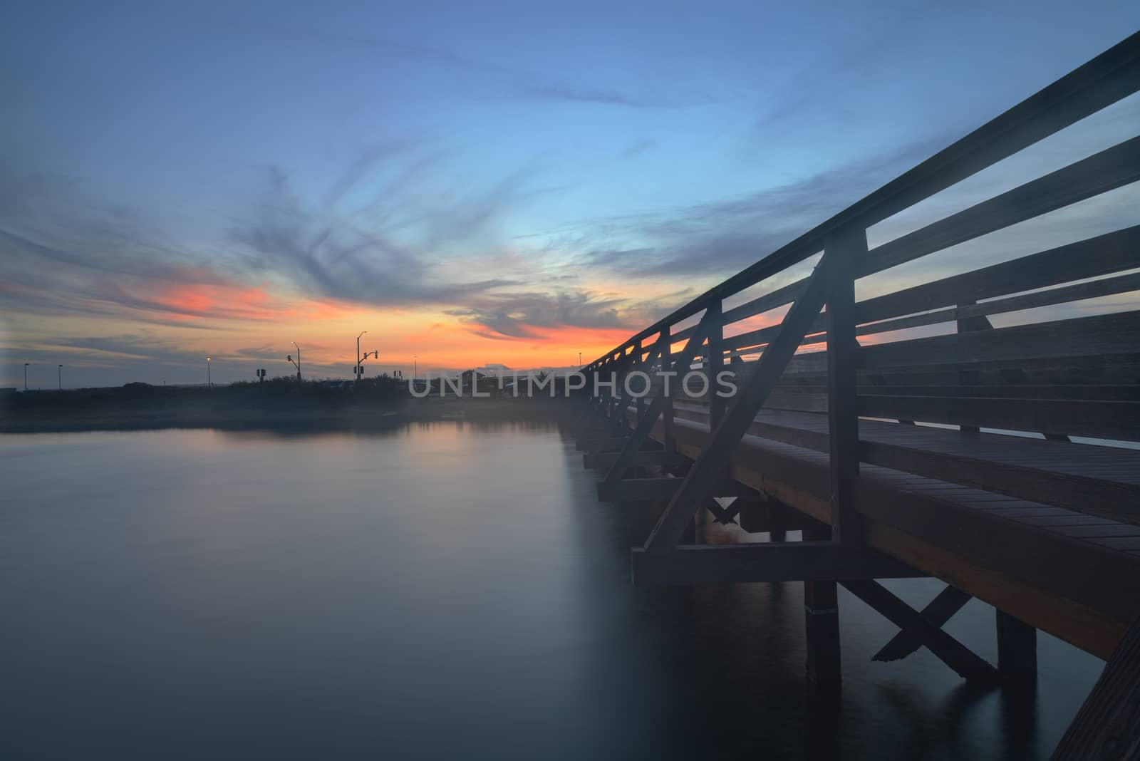 Wooden Boardwalk at sunset, to journey through Bolsa Chica Wetlands preserve in Huntington Beach, California, United States