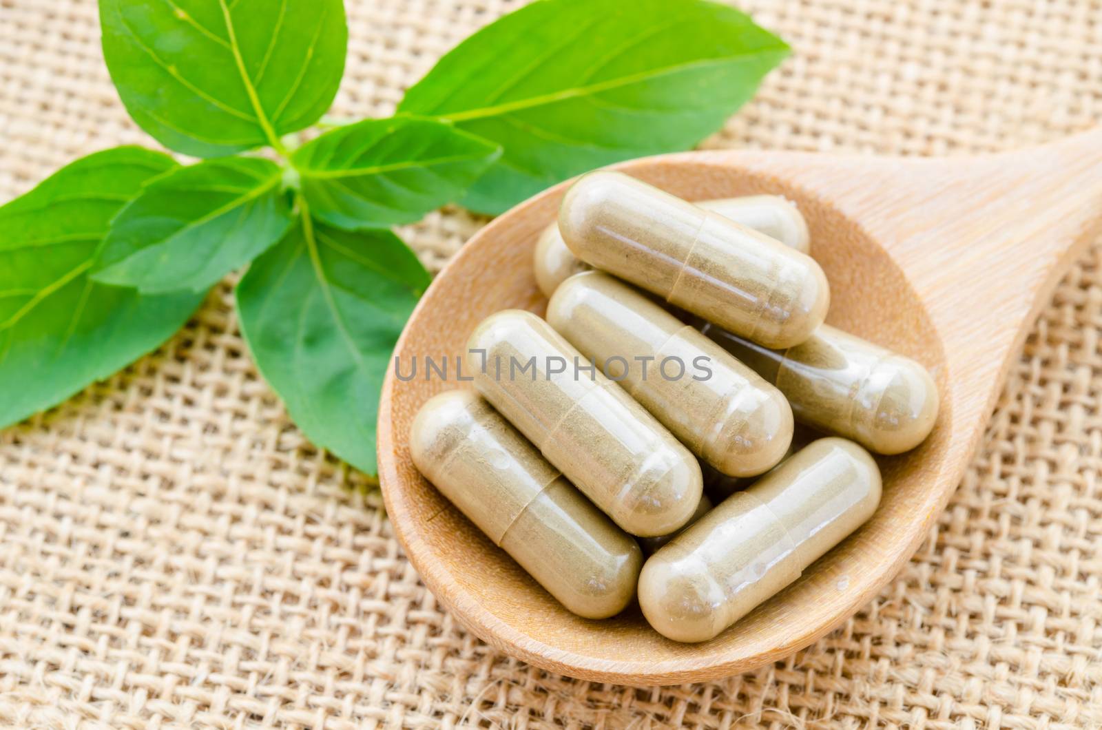 Herbal Medicine with green leaf on sack background.
