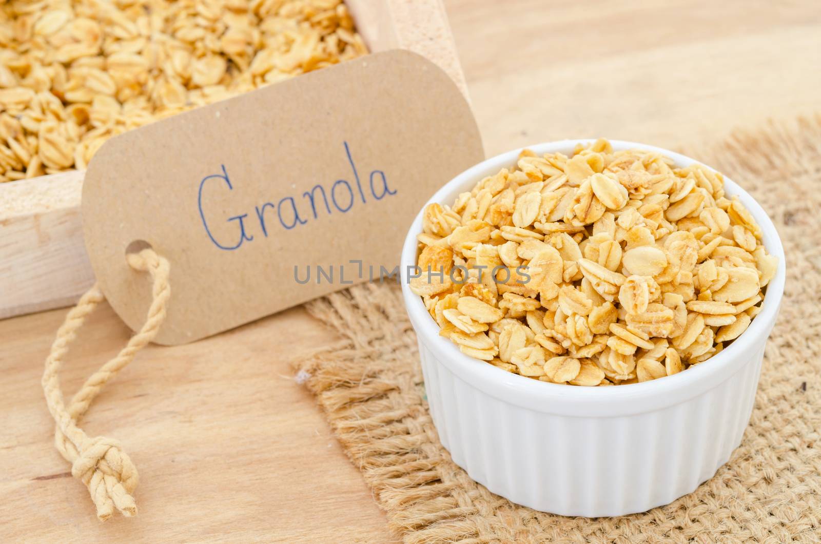 oatmeal granola in white cup with granola tag paper.