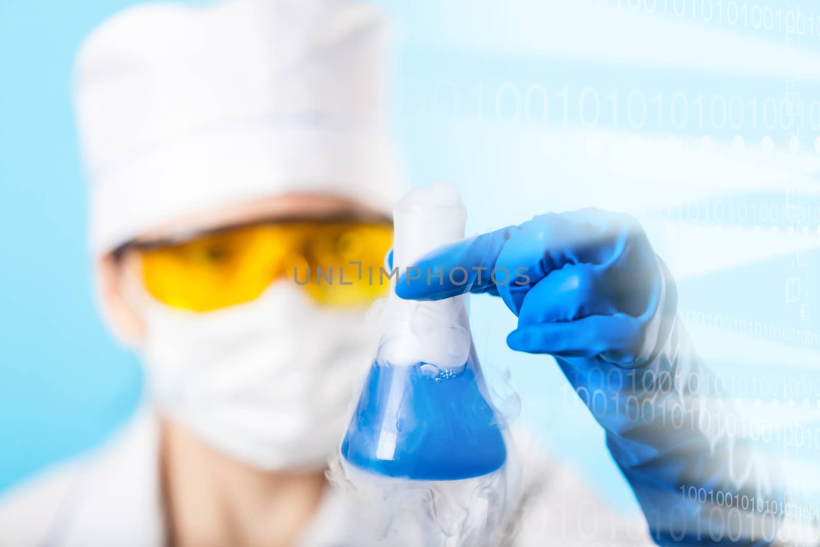 Woman chemist examines test tube on a blue background