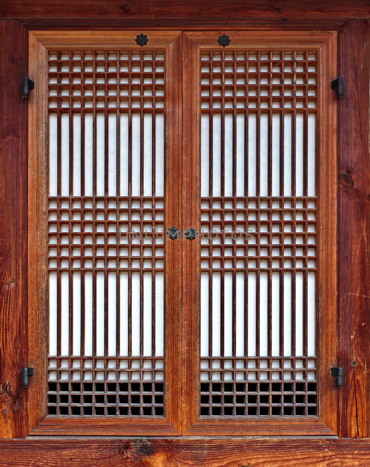 Vintage Korean style wooden window with closed laced shutters filling frame