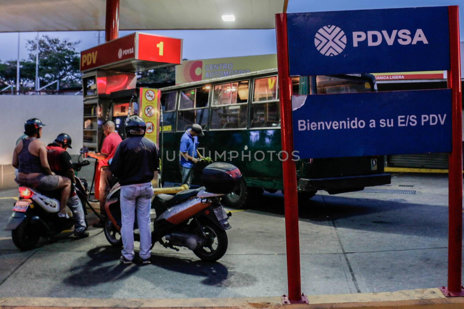 VENEZUELA, Caracas: Motorcyclists queue at a gas station in Caracas, on February 17, 2016. Venezuela's President Nicolas Maduro said Wednesday he would raise the price of gasoline for the first time in 20 years, as he faces growing pressure to ease an economic crisis. Maduro said in a televised address he would raise the pump price of premium gasoline from its current super-low level of $0.01 to the equivalent of $0.95 at the fixed official exchange rate, in a country where citizens are struggling with soaring inflation.