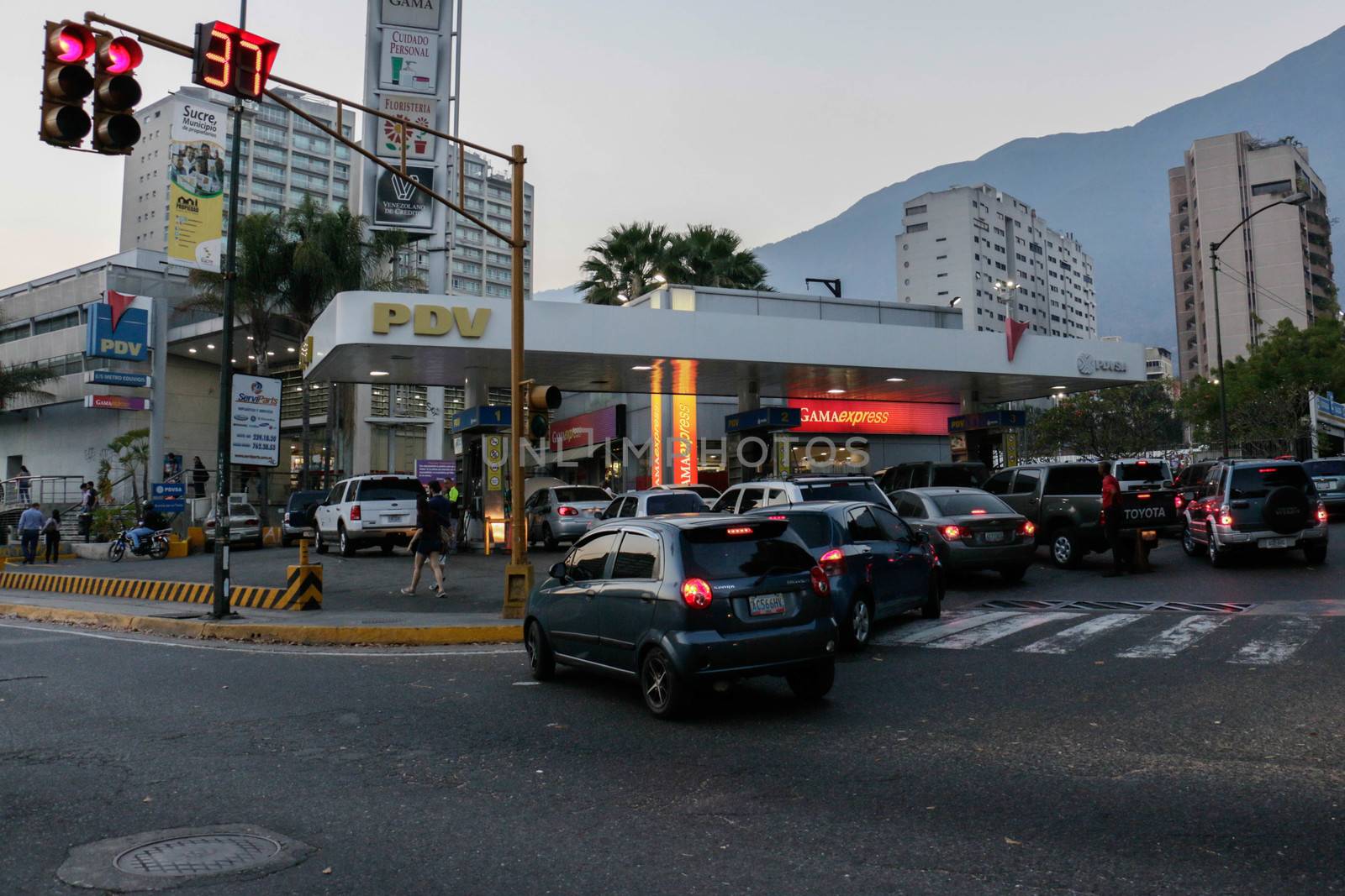 VENEZUELA, Caracas: Cars queue at a gas station in Caracas, on February 17, 2016. Venezuela's President Nicolas Maduro said Wednesday he would raise the price of gasoline for the first time in 20 years, as he faces growing pressure to ease an economic crisis. Maduro said in a televised address he would raise the pump price of premium gasoline from its current super-low level of $0.01 to the equivalent of $0.95 at the fixed official exchange rate, in a country where citizens are struggling with soaring inflation.