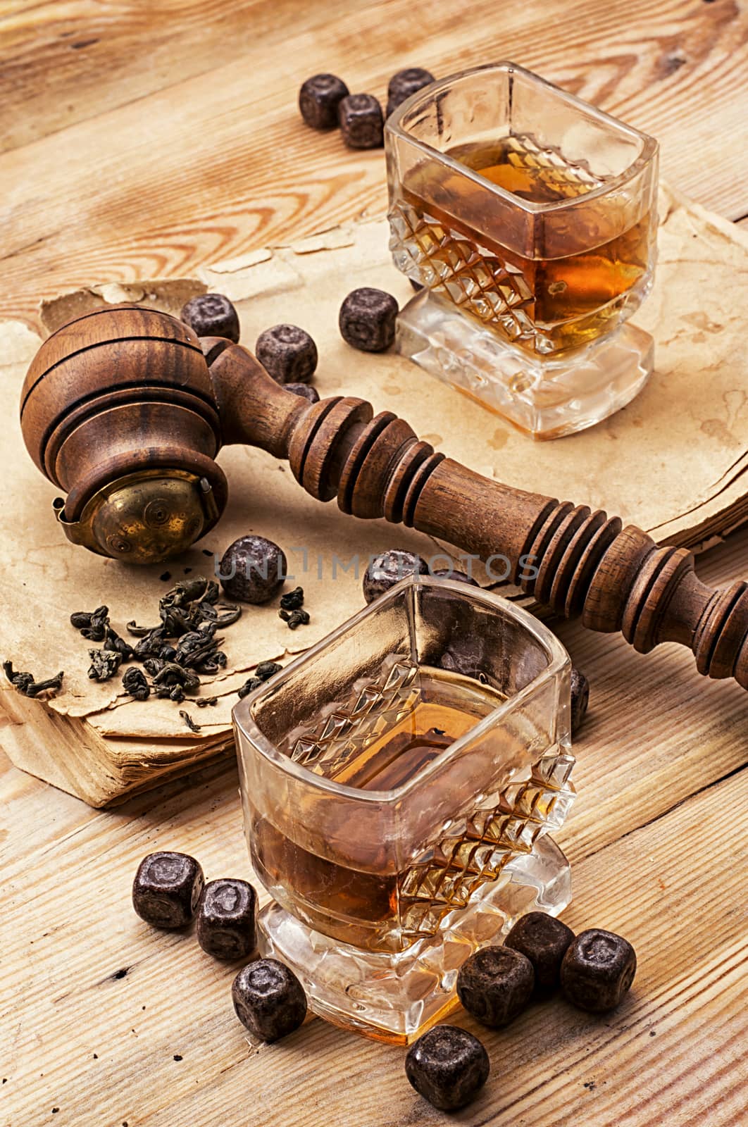 Smoking pipe in a retro style,dark chocolate and glasses of whiskey on wooden background