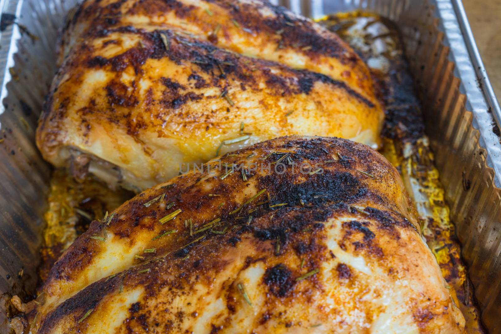 Duck breast fried finished in an aluminum tray fresh from the oven.