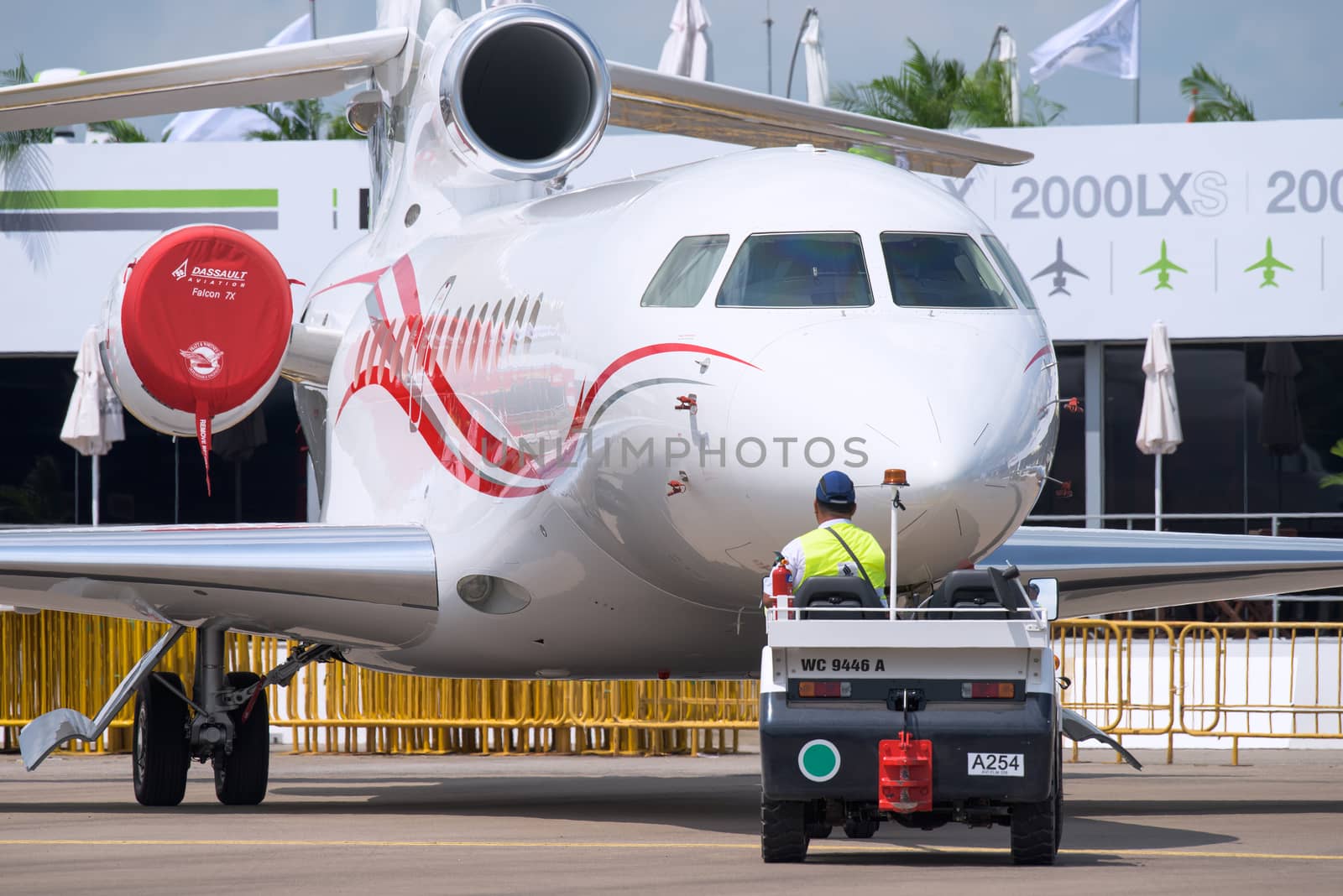 Singapore - February 14, 2016: Tri engine Dassault Falcon 7X being pushed into position before the opening of Singapore Airshow at Changi Exhibition Centre in Singapore.