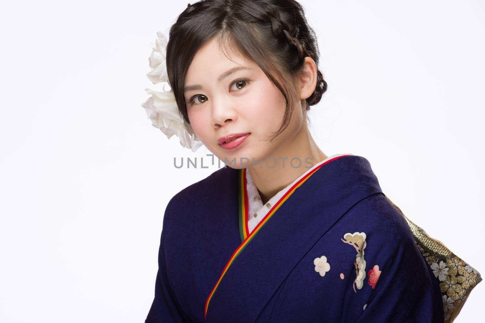 A portrait of a beautiful young Japanese girl in a blue kimono for her coming of age ceremony on her 20th birthday.