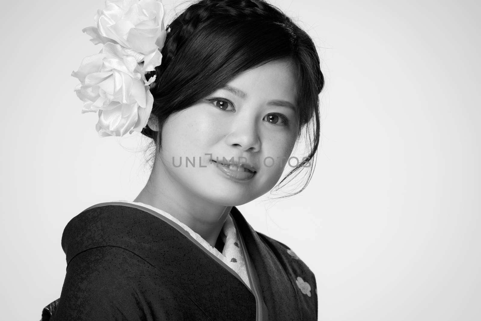 A portrait of a beautiful young Japanese girl in a blue kimono for her coming of age ceremony on her 20th birthday.