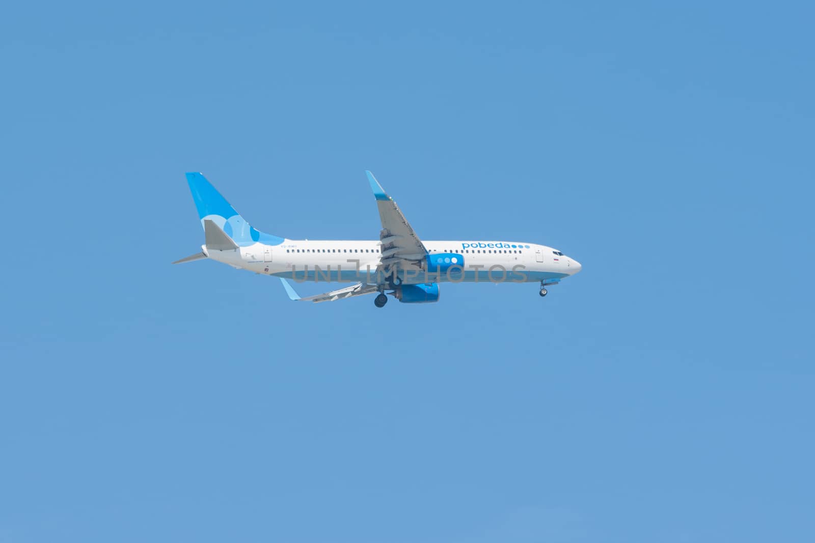 Anapa, Russia - September 16, 2015: Plane victory airlines flying in the blue sky getting ready to go to the land