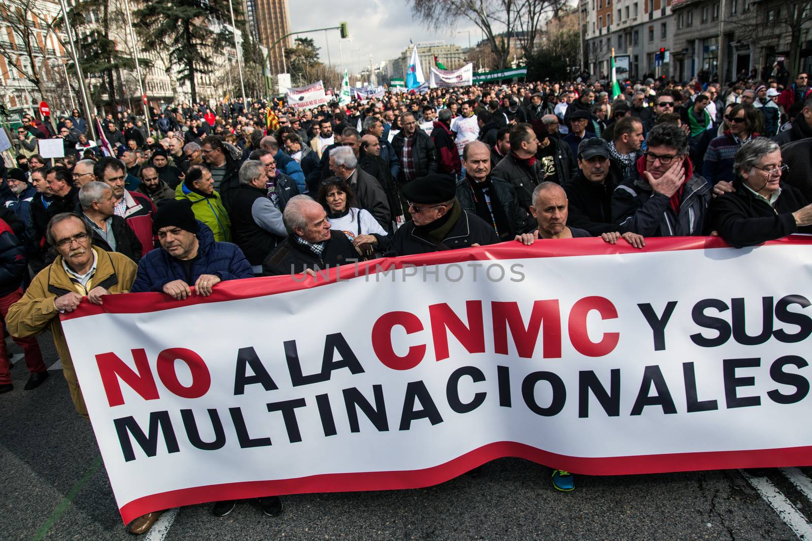 SPAIN, Madrid: Protesters march behind a banner which reads 'No to the CNMC (National Markets and Competition Commission) and its multinational companies' as thousands of taxi drivers demonstrate against deregulation and ride-hailing companies such as Uber, in Madrid, on February 18, 2016.