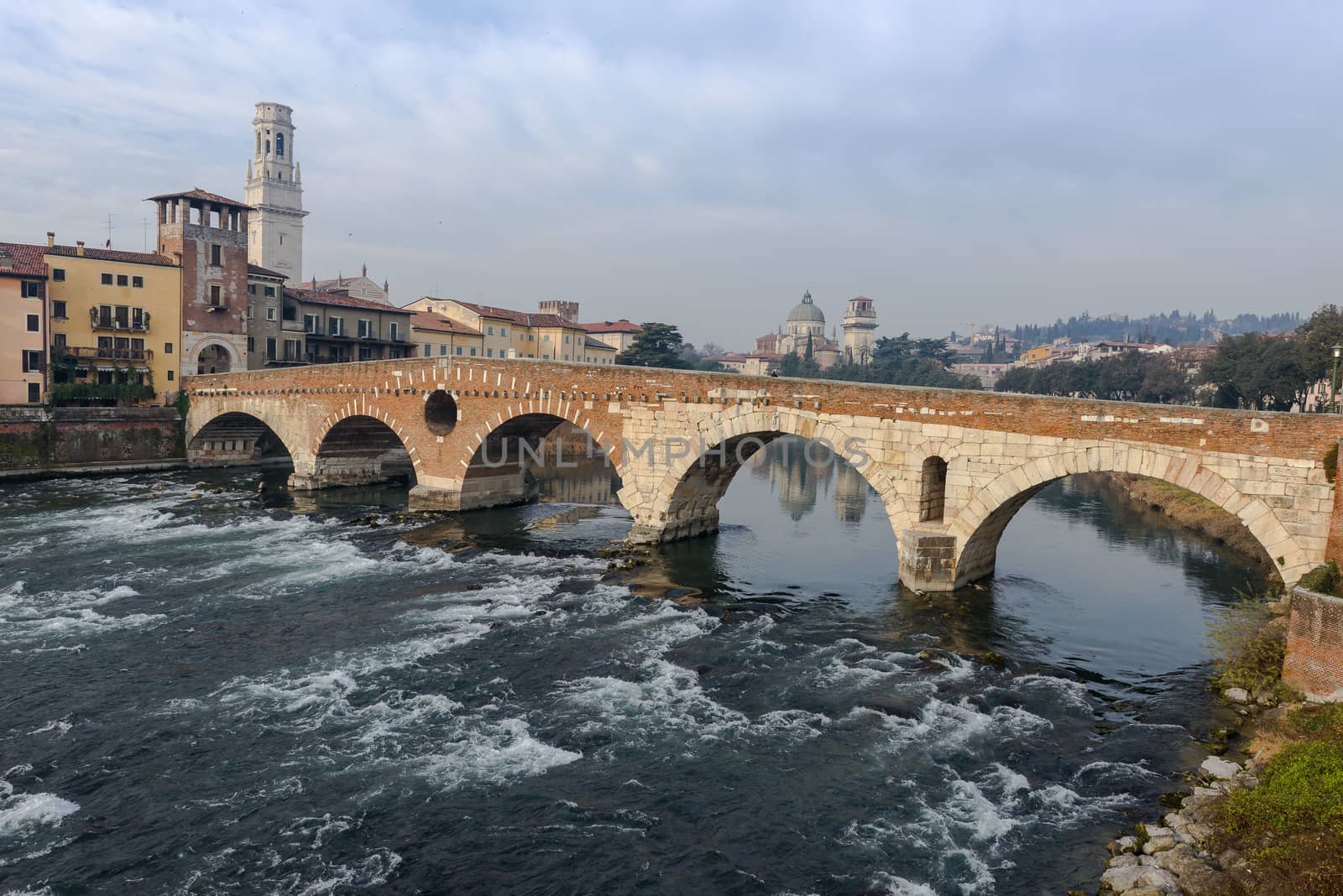 Ponte Pietra on river Adige, ancient roman bridge in the old town of Verona, Italy