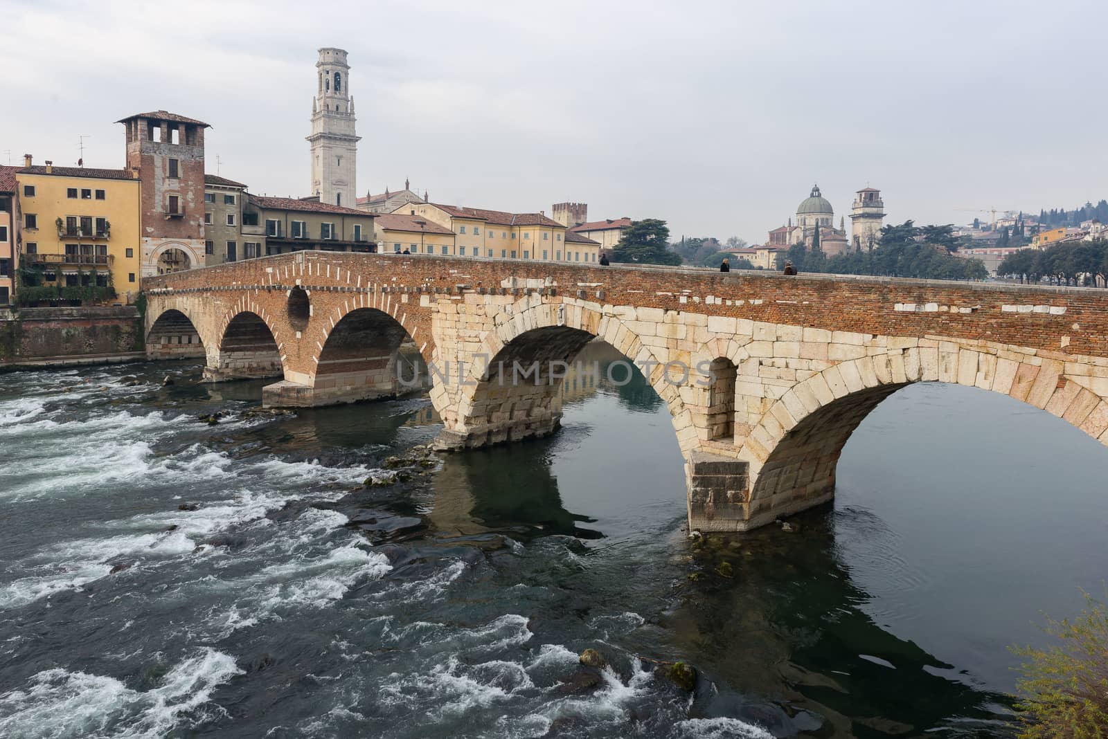 Ponte Pietra on river Adige, ancient roman bridge in the old town of Verona, Italy