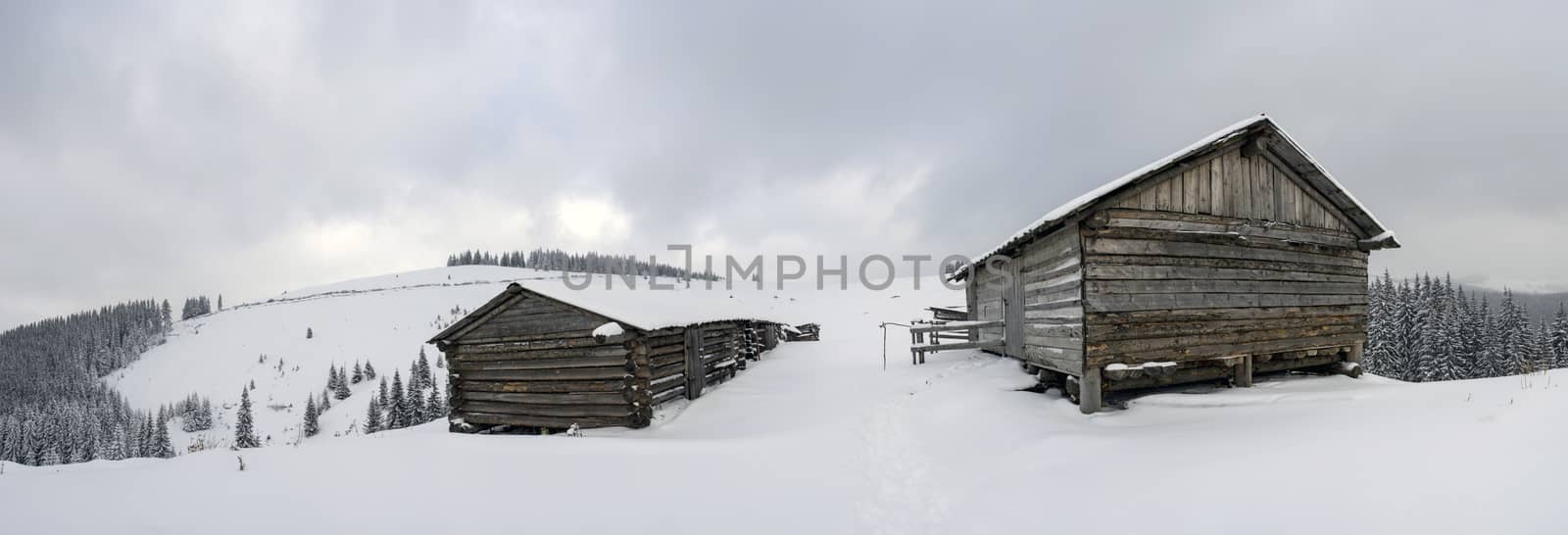 cabins in winter mountain in the evening by dolnikow