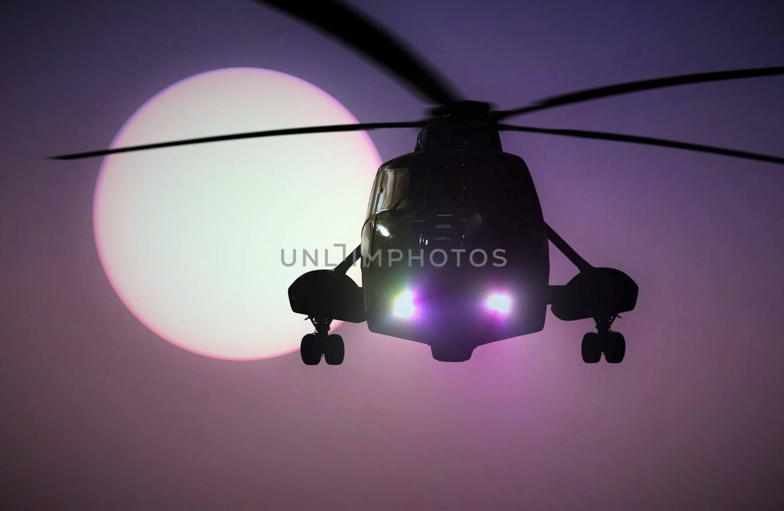Military Helicopter flying at sunset
