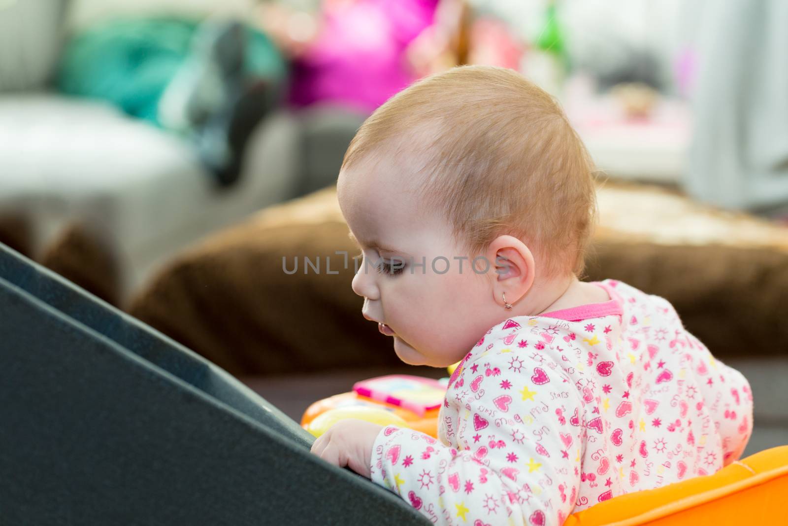 Happy cute little one year old girl indoor in white pink dress