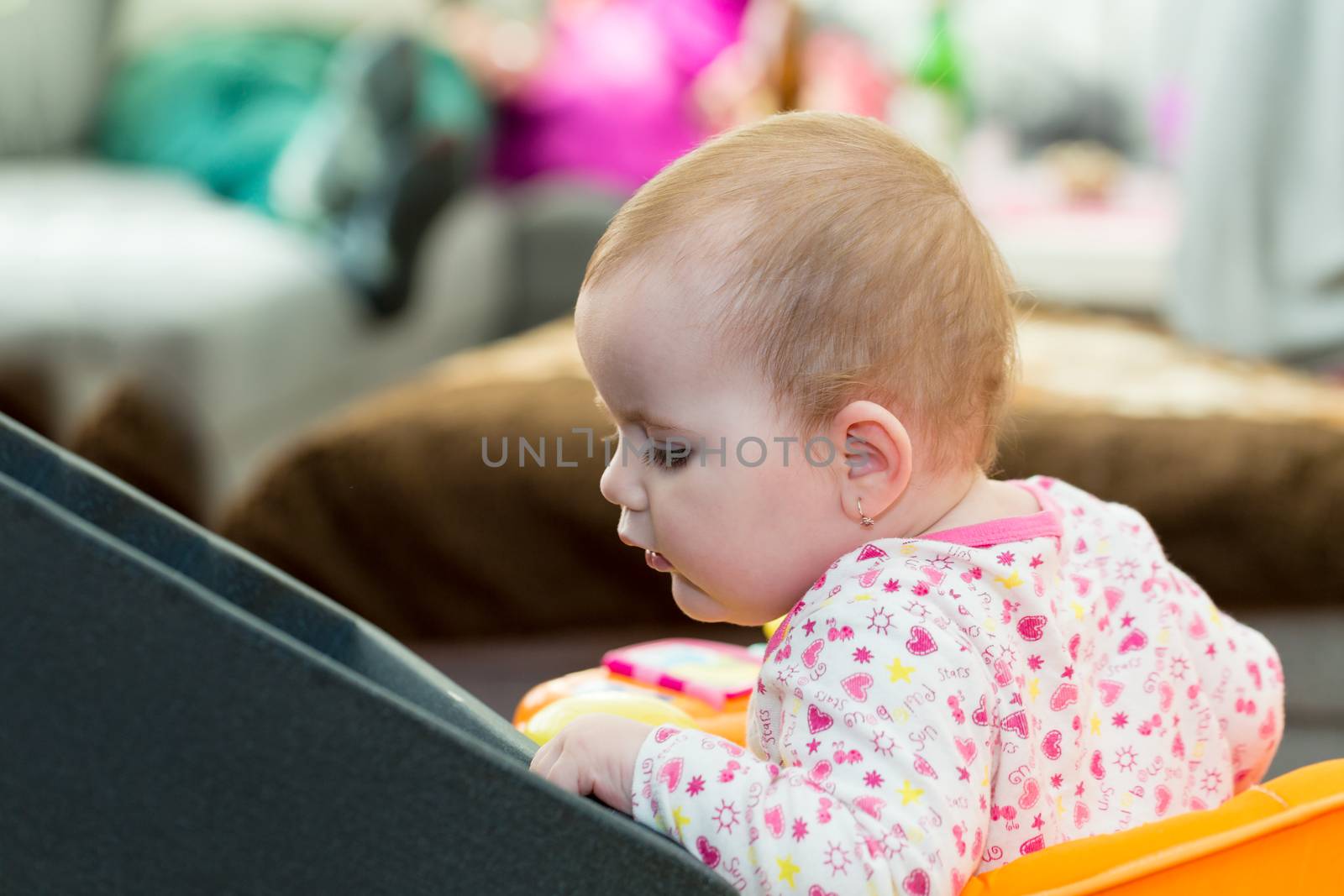 Happy cute little one year old girl indoor in white pink dress