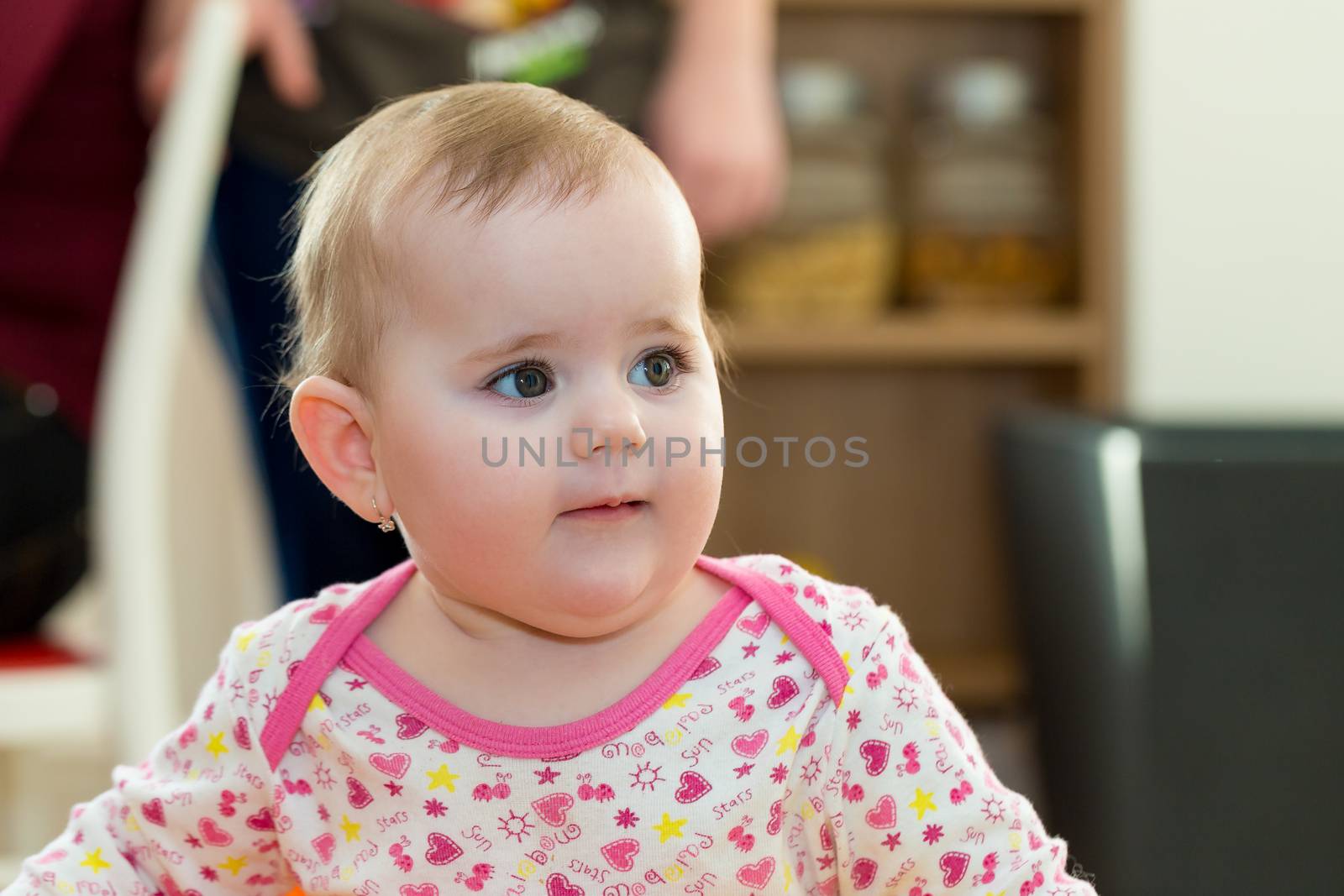 Happy cute little one year old girl indoor in white pink dress