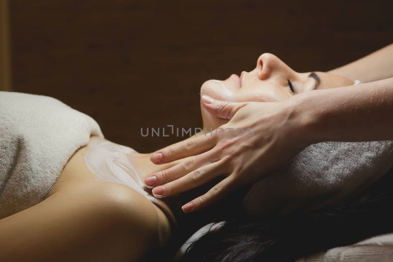 Close-up of young woman with facial mask by sarymsakov