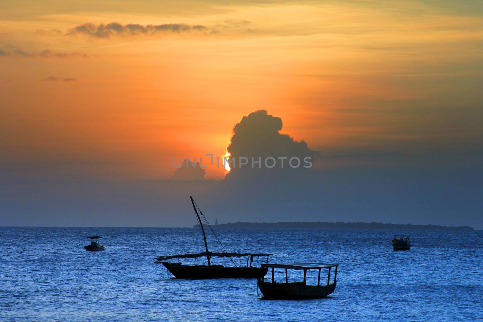 Traditional fishing boats in ocean on sunset. Zanzibar