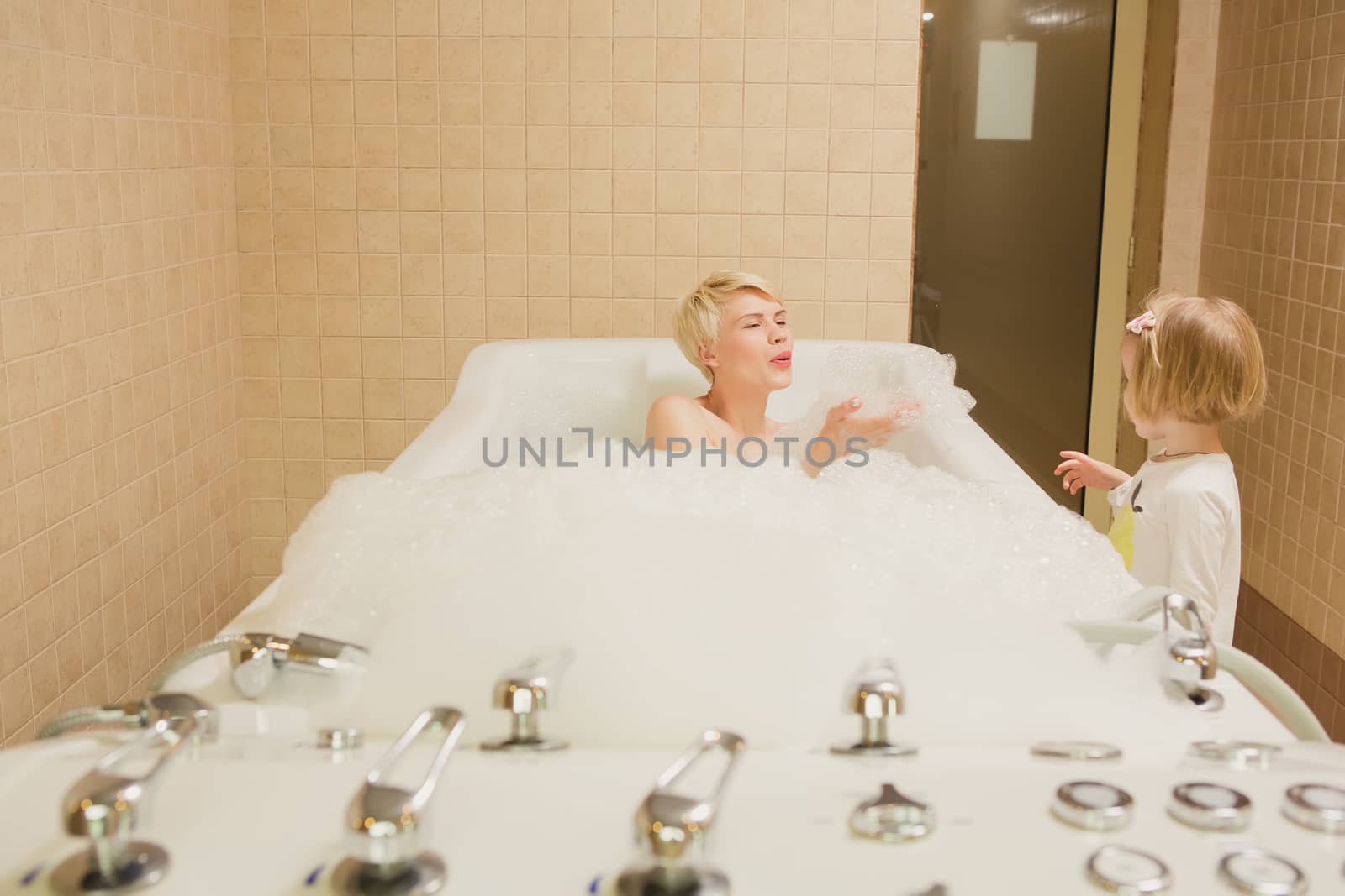 A woman and a hydro massage. She receives medical treatments for relaxation.