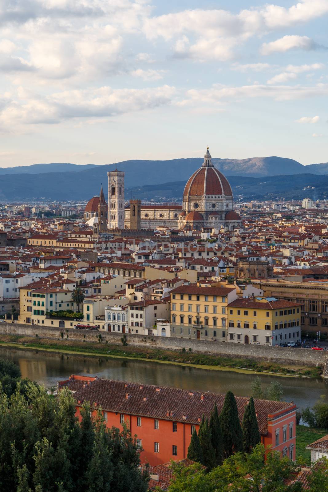 Top view of Florence city with old and historical buildings, on cloudy sunrise or sunset sky background.