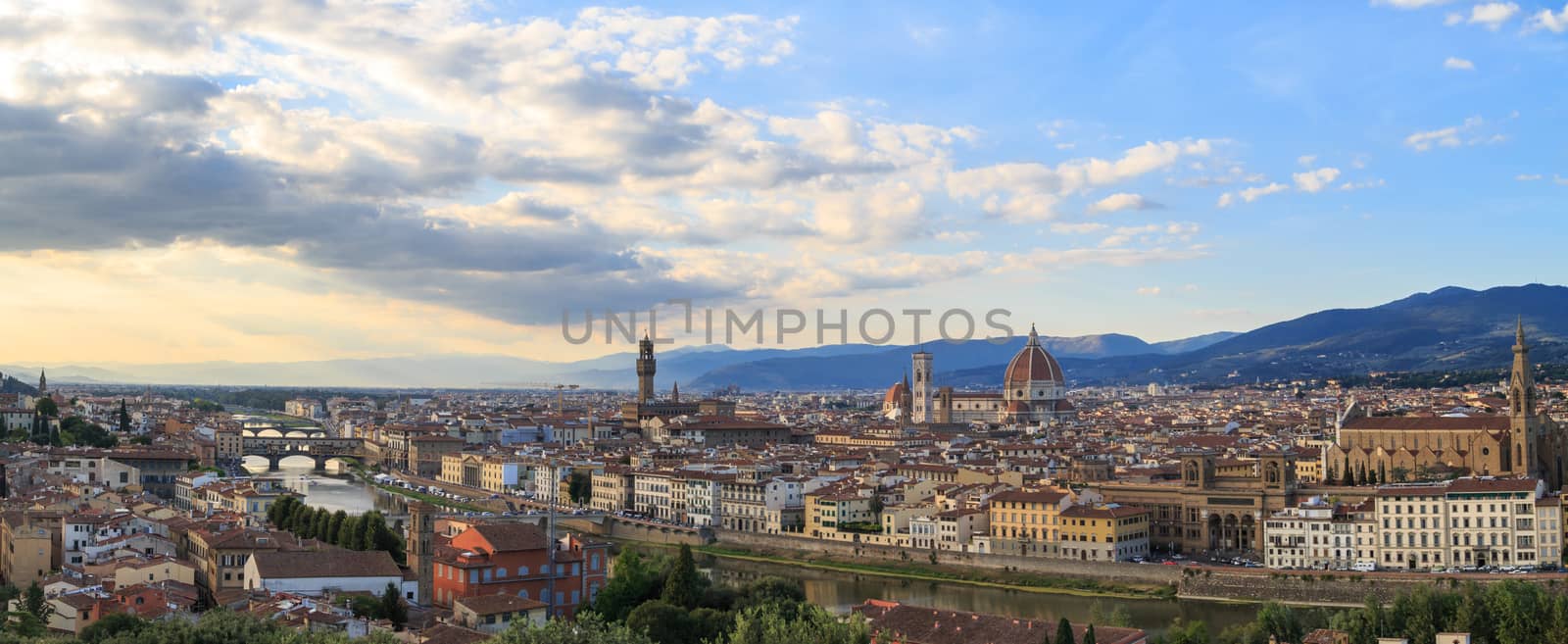 Top view of Florence city with arno river bridges and historical buildings, on cloudy sunrise or sunset sky background.