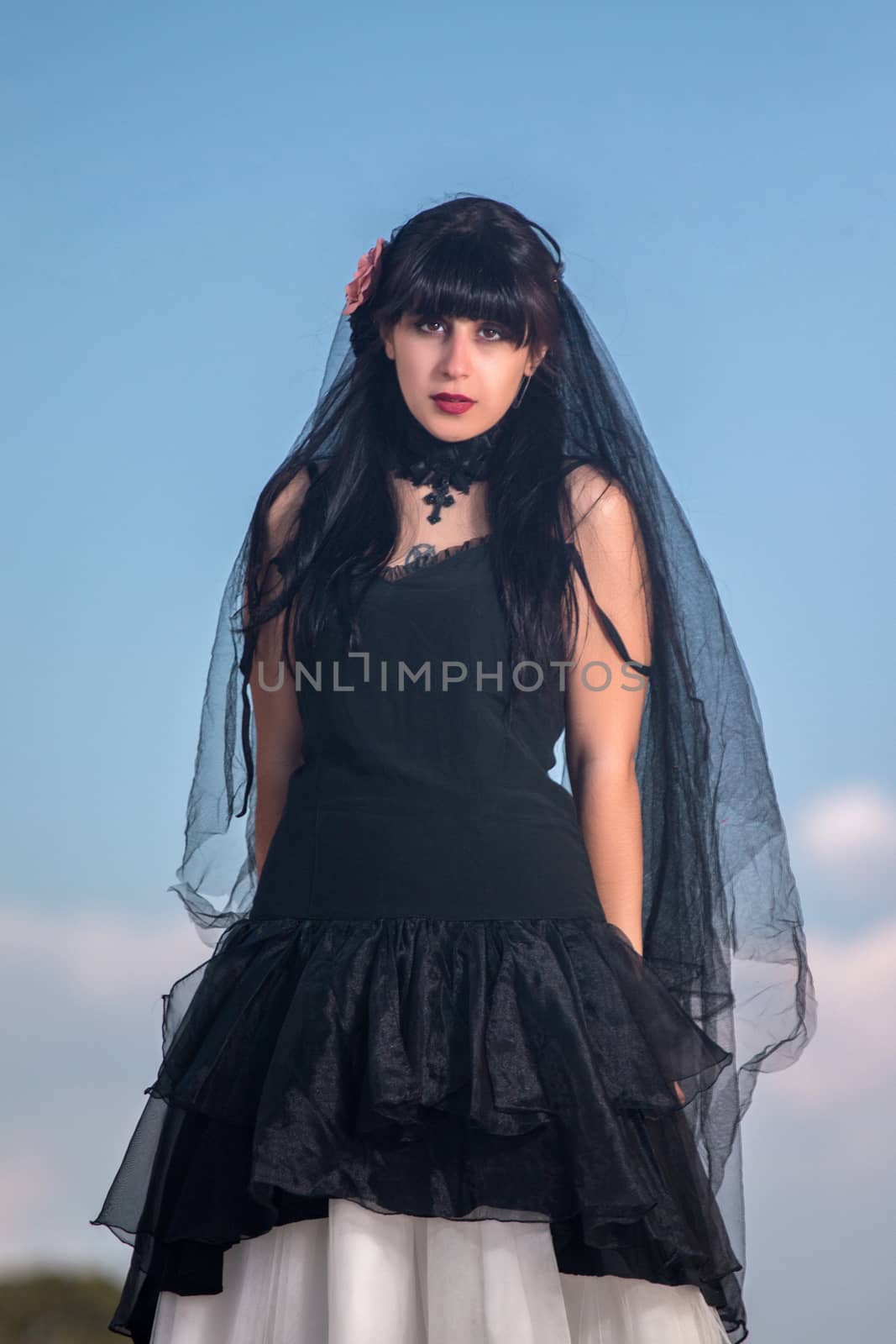 View of a beautiful young girl in gothic dark clothes.