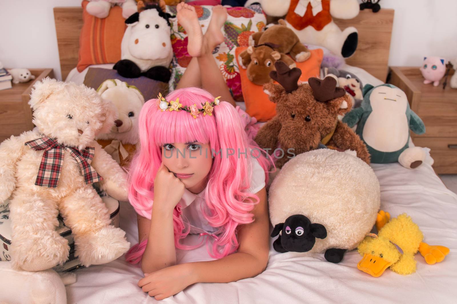 young girl in a bedroom in a pink cute dress