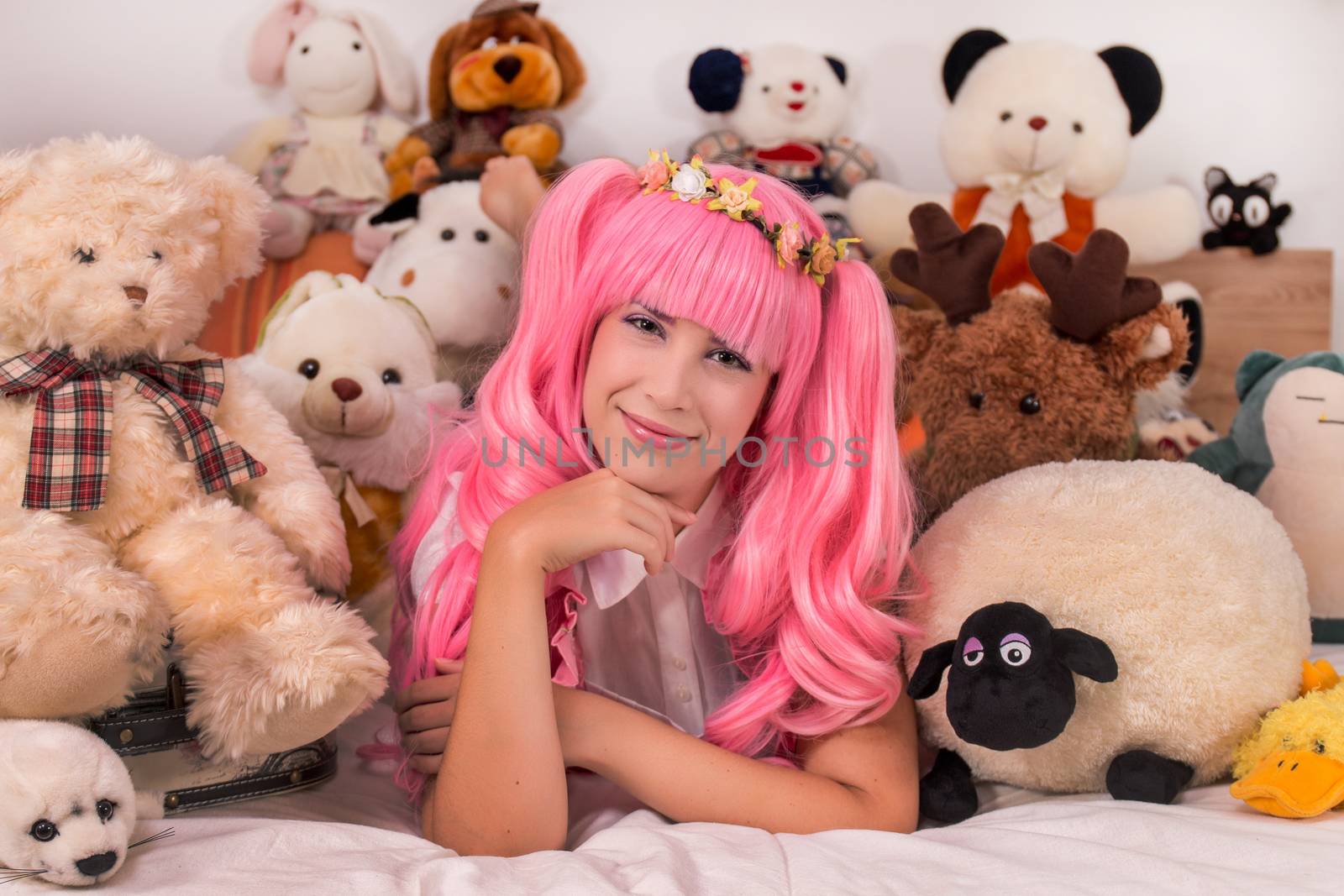 young girl in a bedroom in a pink cute dress