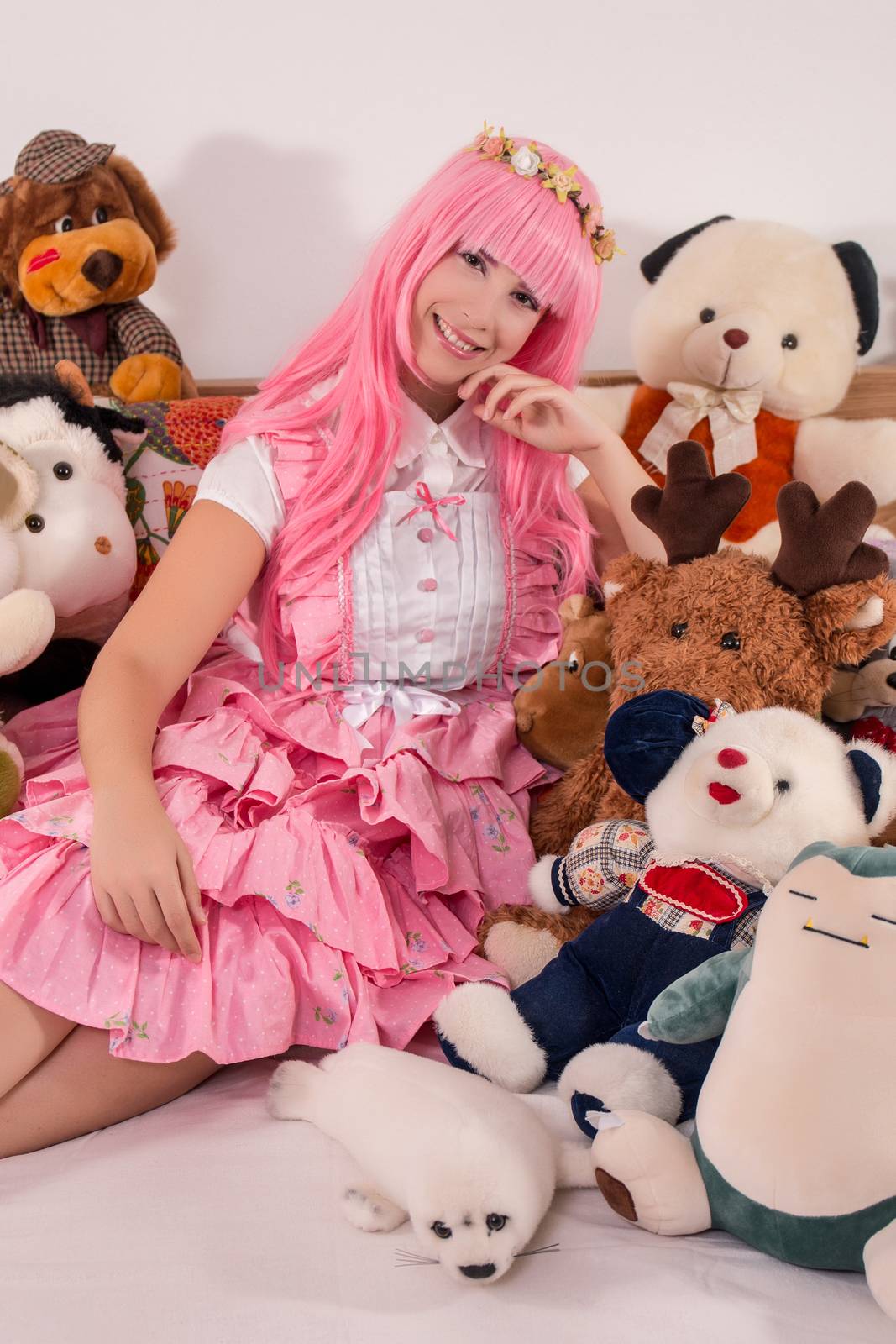 young girl in a bedroom in a pink cute dress