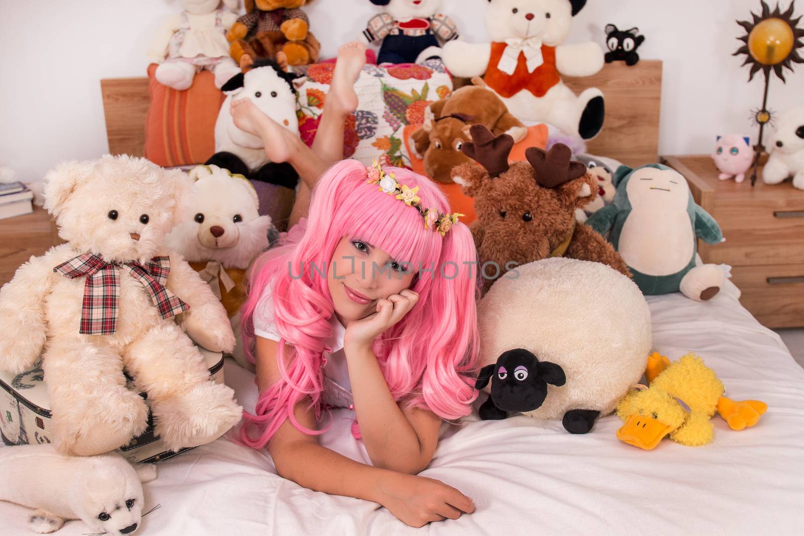 young girl in a bedroom in a pink cute dress