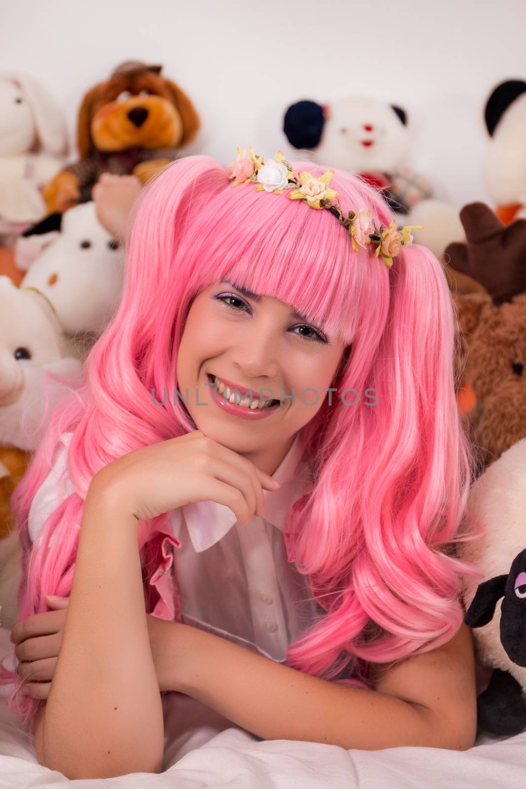 young girl in a bedroom in a pink cute dress