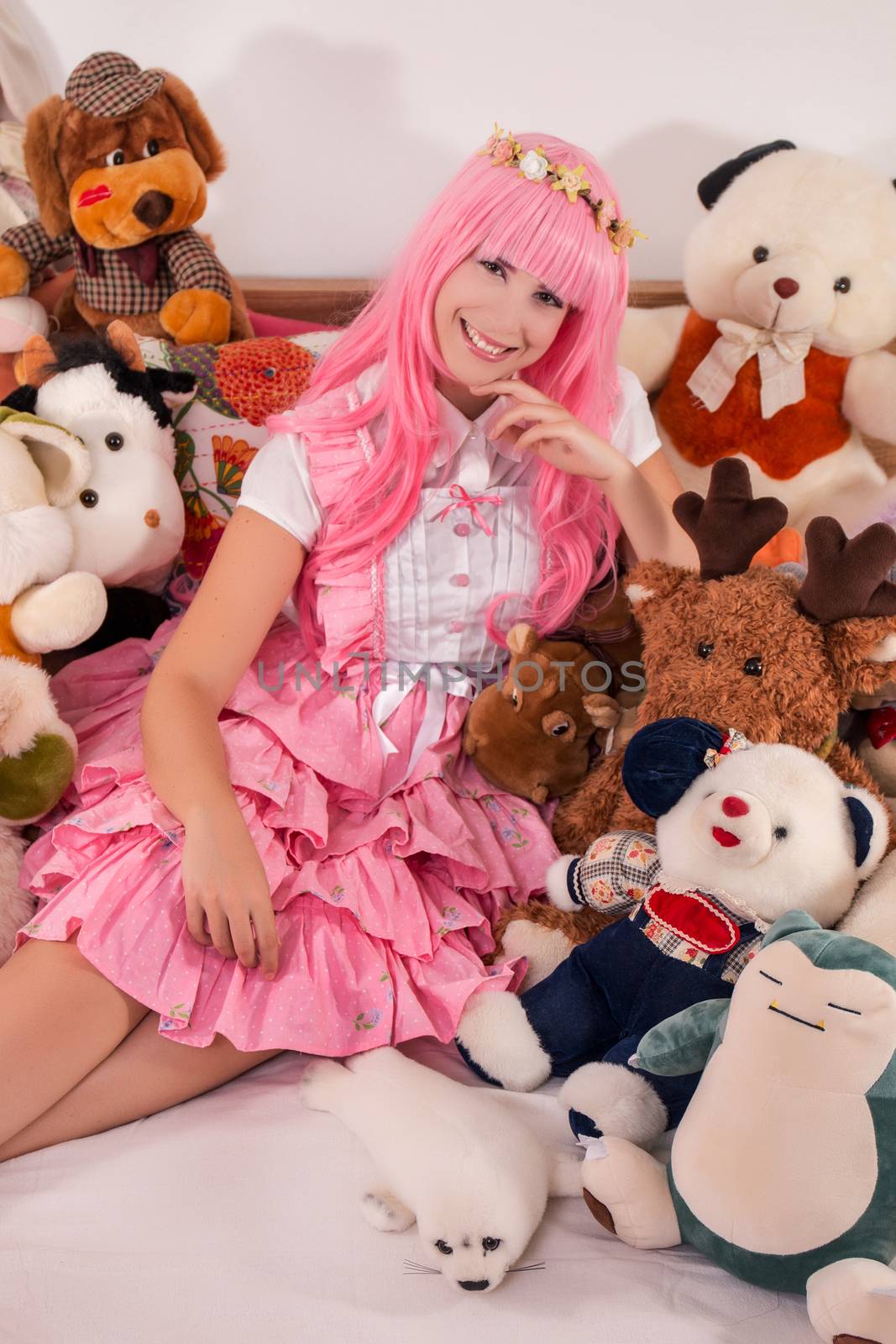 young girl in a bedroom in a pink cute dress