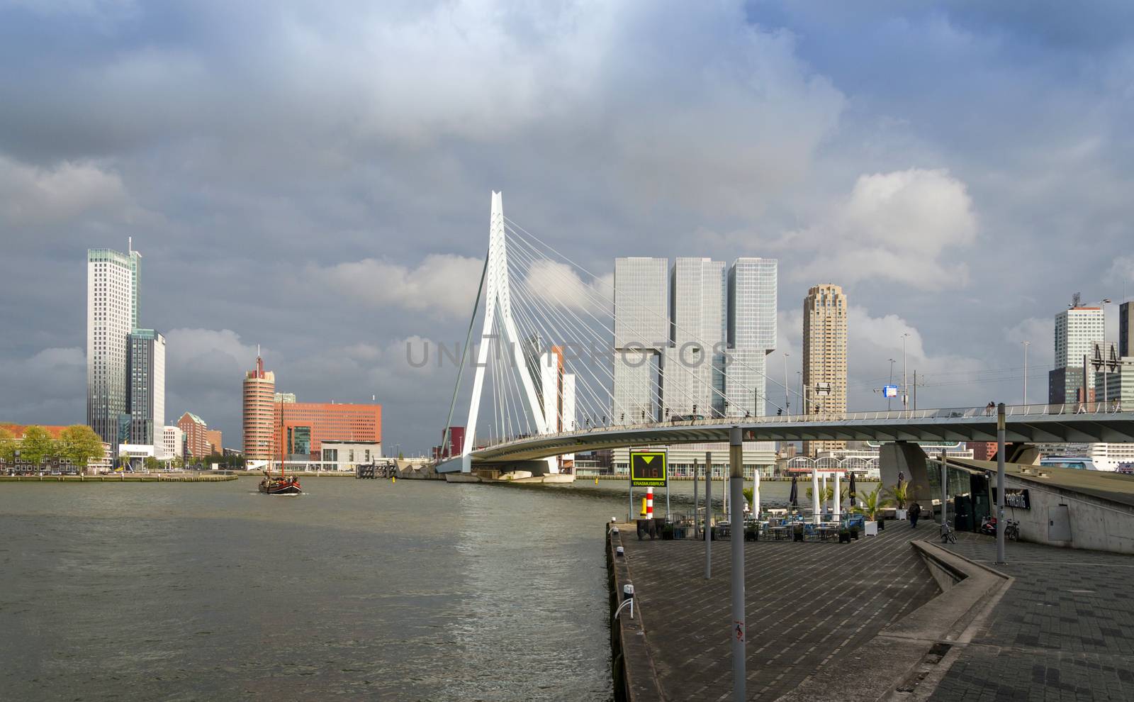 Rotterdam, Netherlands - May 9, 2015: Erasmus Bridge with Skyscraper in Rotterdam, The Netherlands. Rotterdam has always been one of the main centres of the shipping industry in the Netherlands.