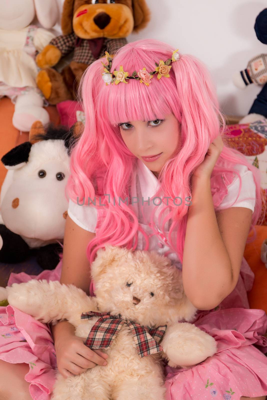 young girl in a bedroom in a pink cute dress