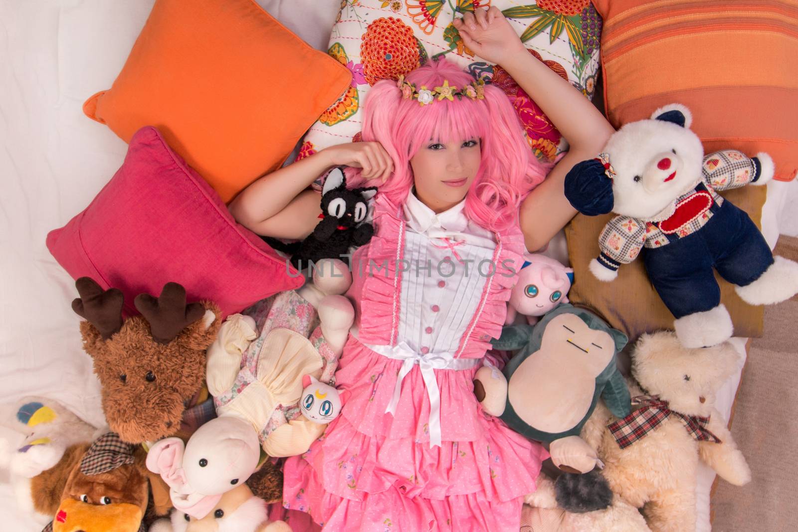 young girl in a bedroom in a pink cute dress