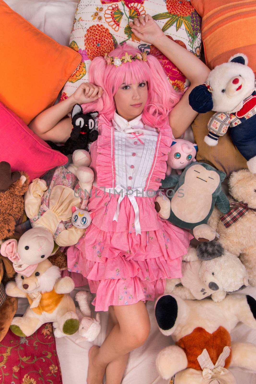 young girl in a bedroom in a pink cute dress