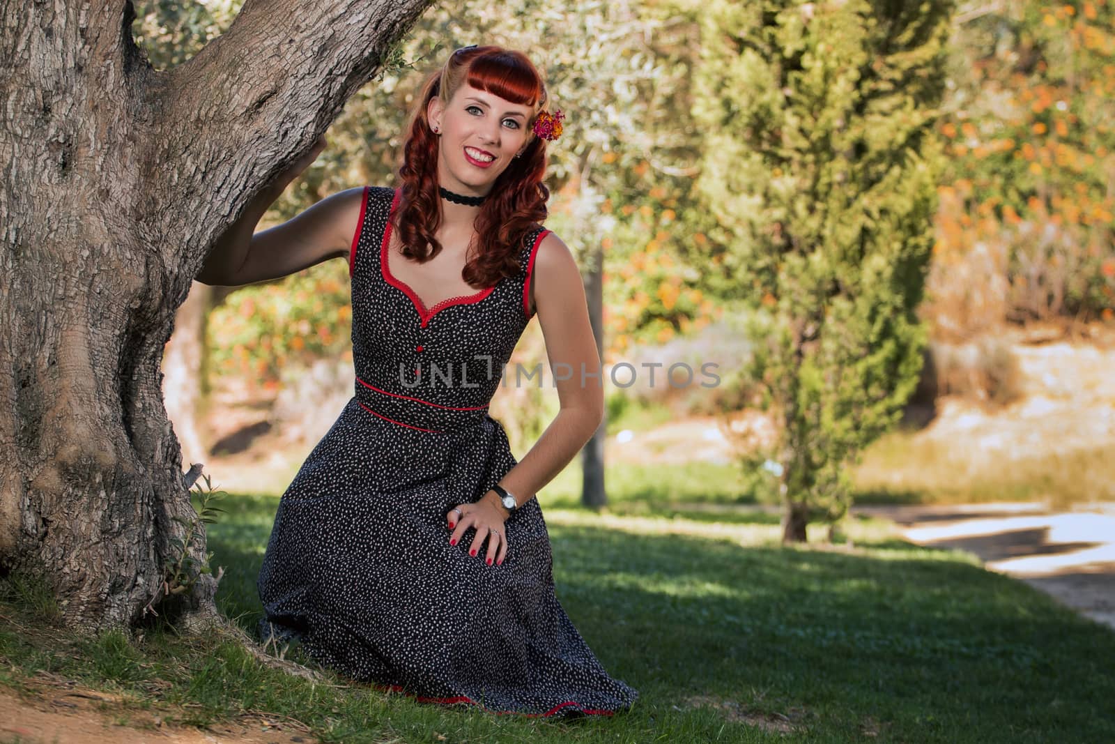 young woman with a simple spring dress posing on the park by membio
