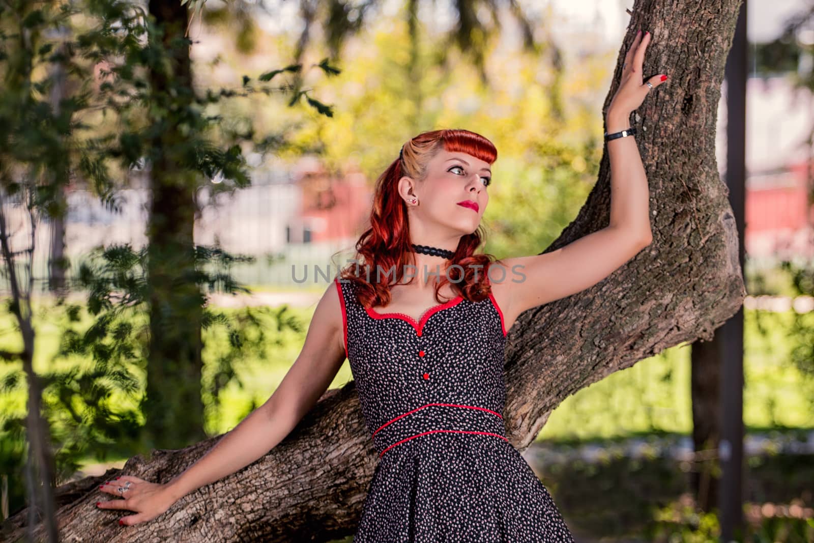 young woman with a simple spring dress posing on the park by membio
