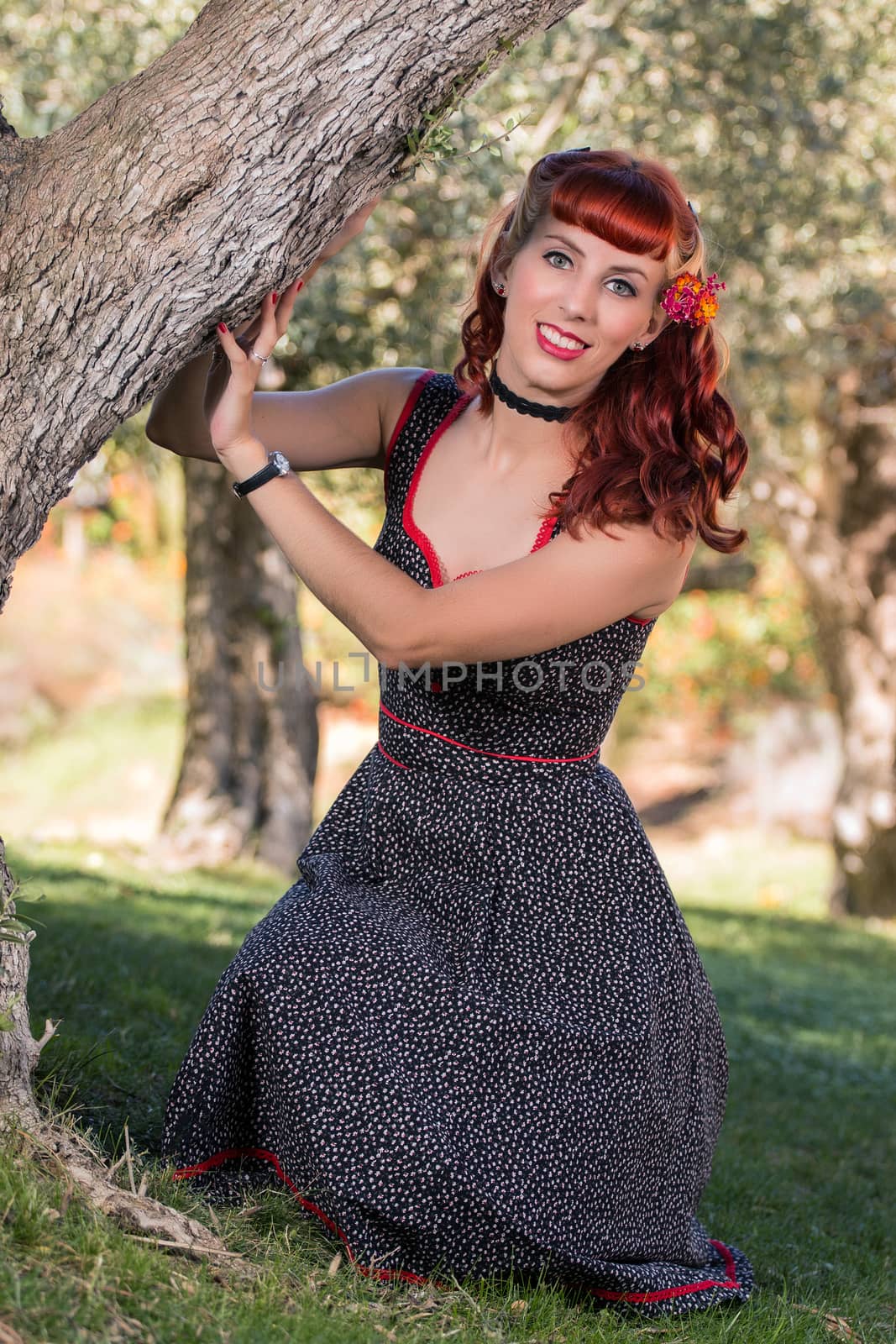 View of a young woman with a simple spring dress posing on the park.