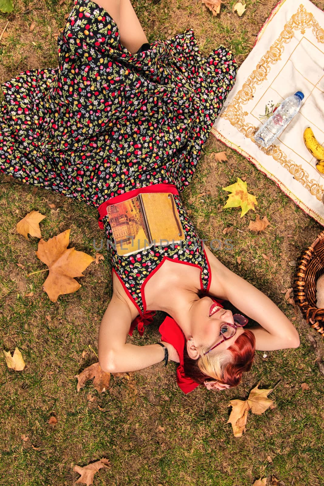 View of a young woman having a picnic in the park.