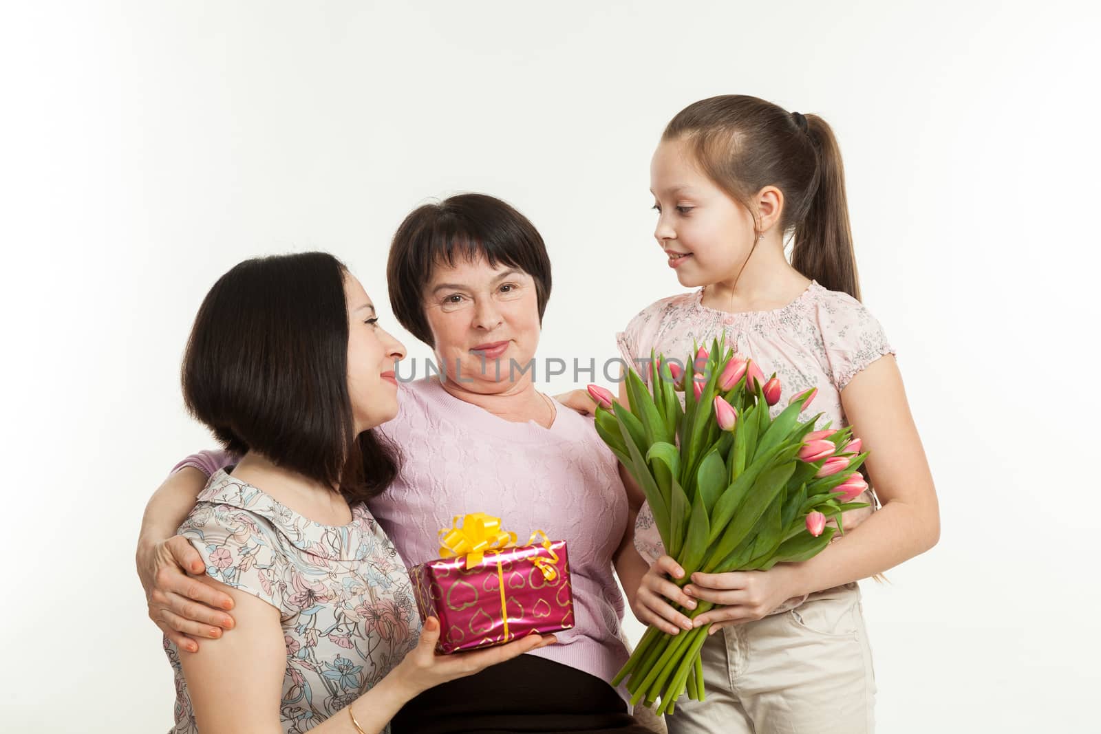 the daughter and the granddaughter give a bouquet  by sveter