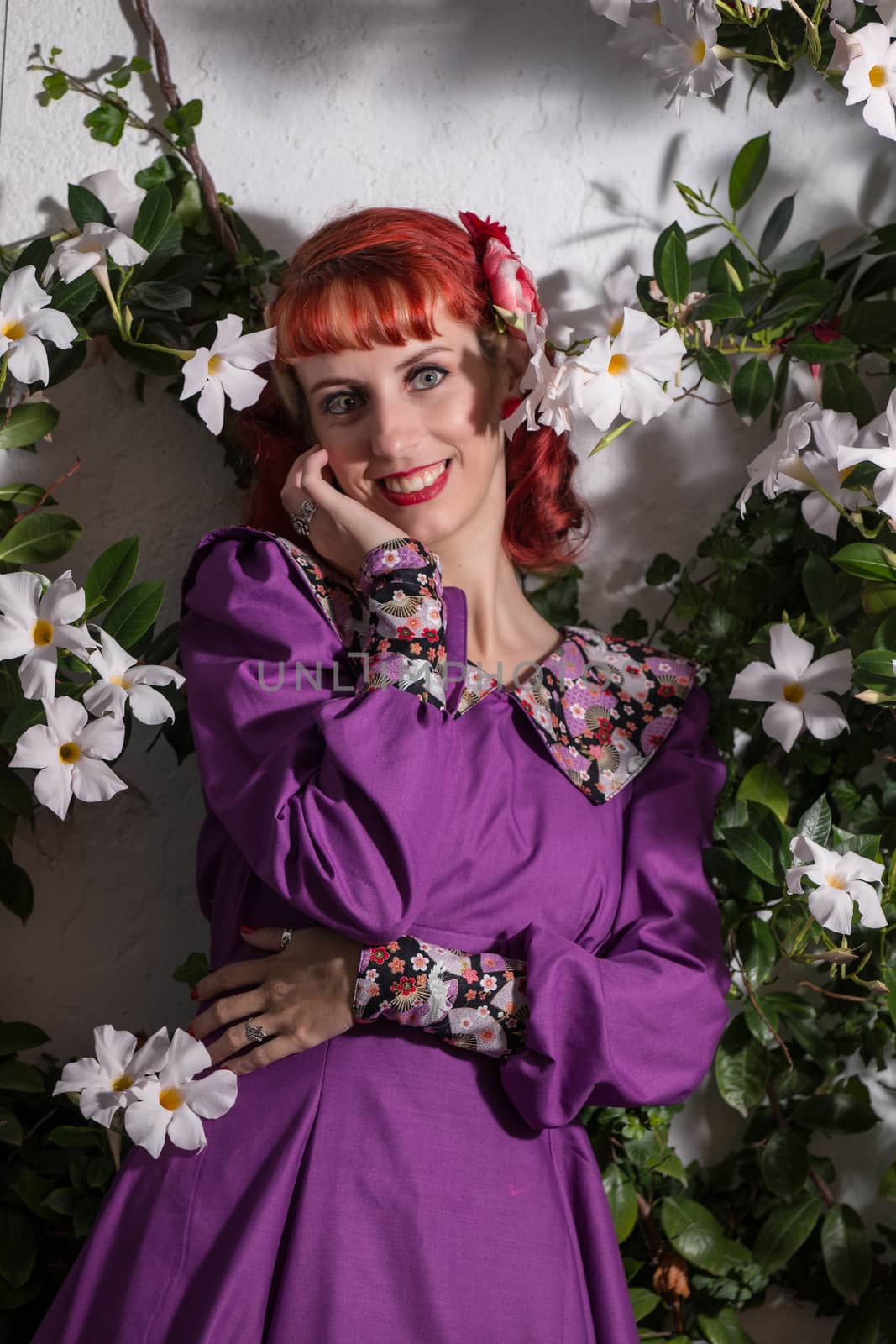 Close up view of a young redhead girl on a retro vintage dress on the urban city.