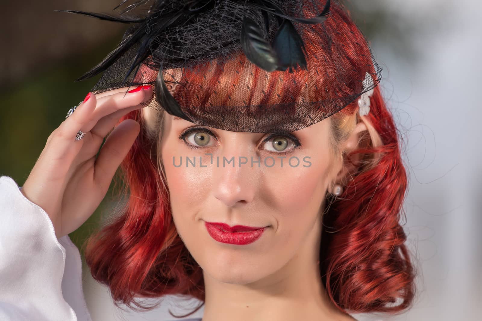 Close up view of a young redhead girl on a retro vintage dress on the urban city.