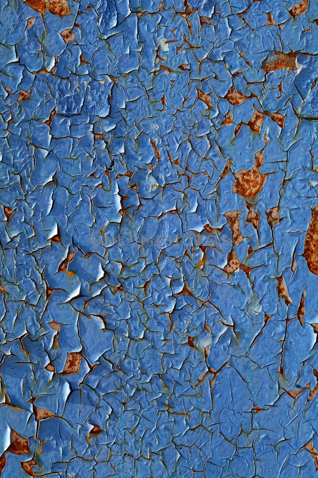 Close-up of peeling paint and rust on a wall