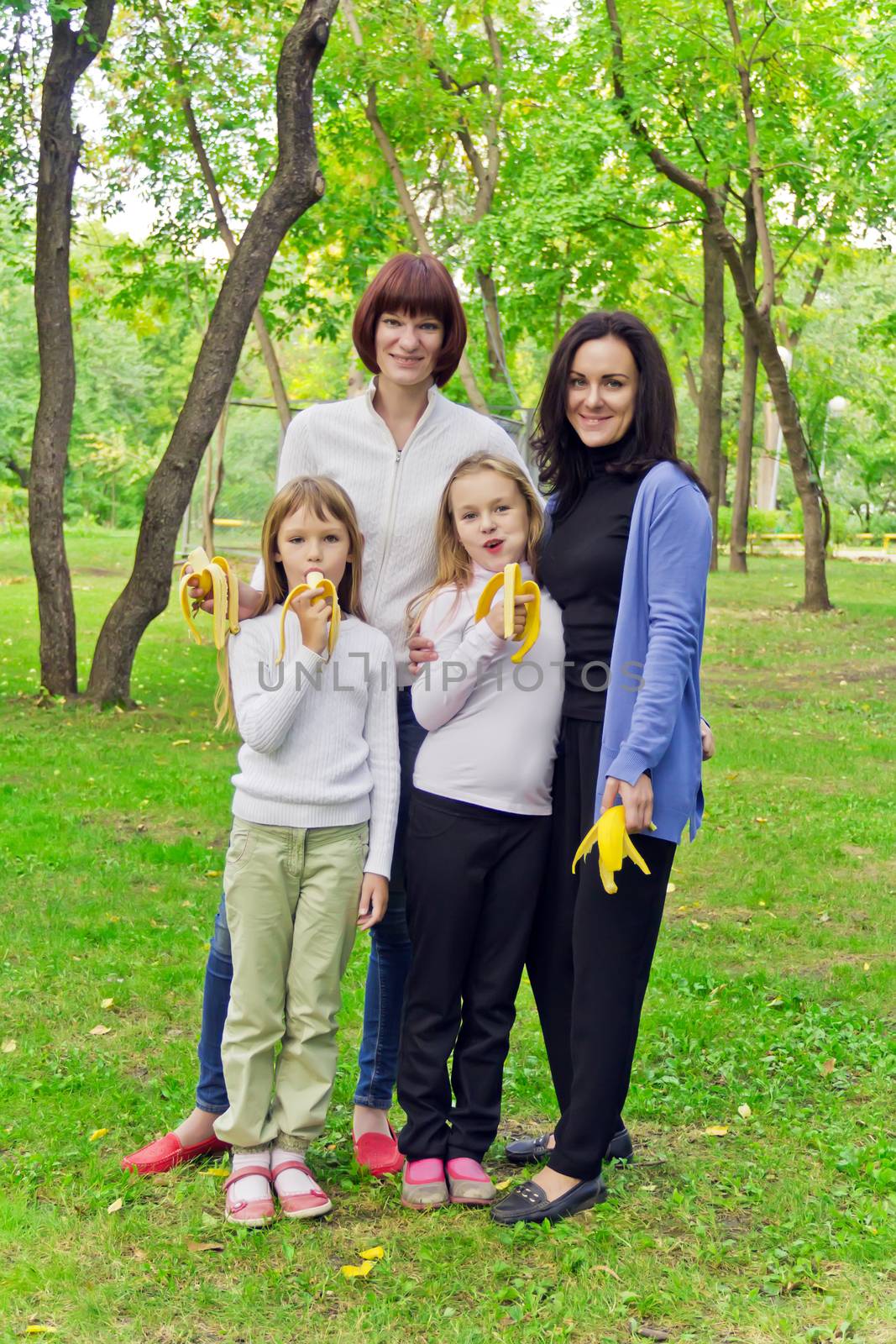 Photo of group people are eating bananas